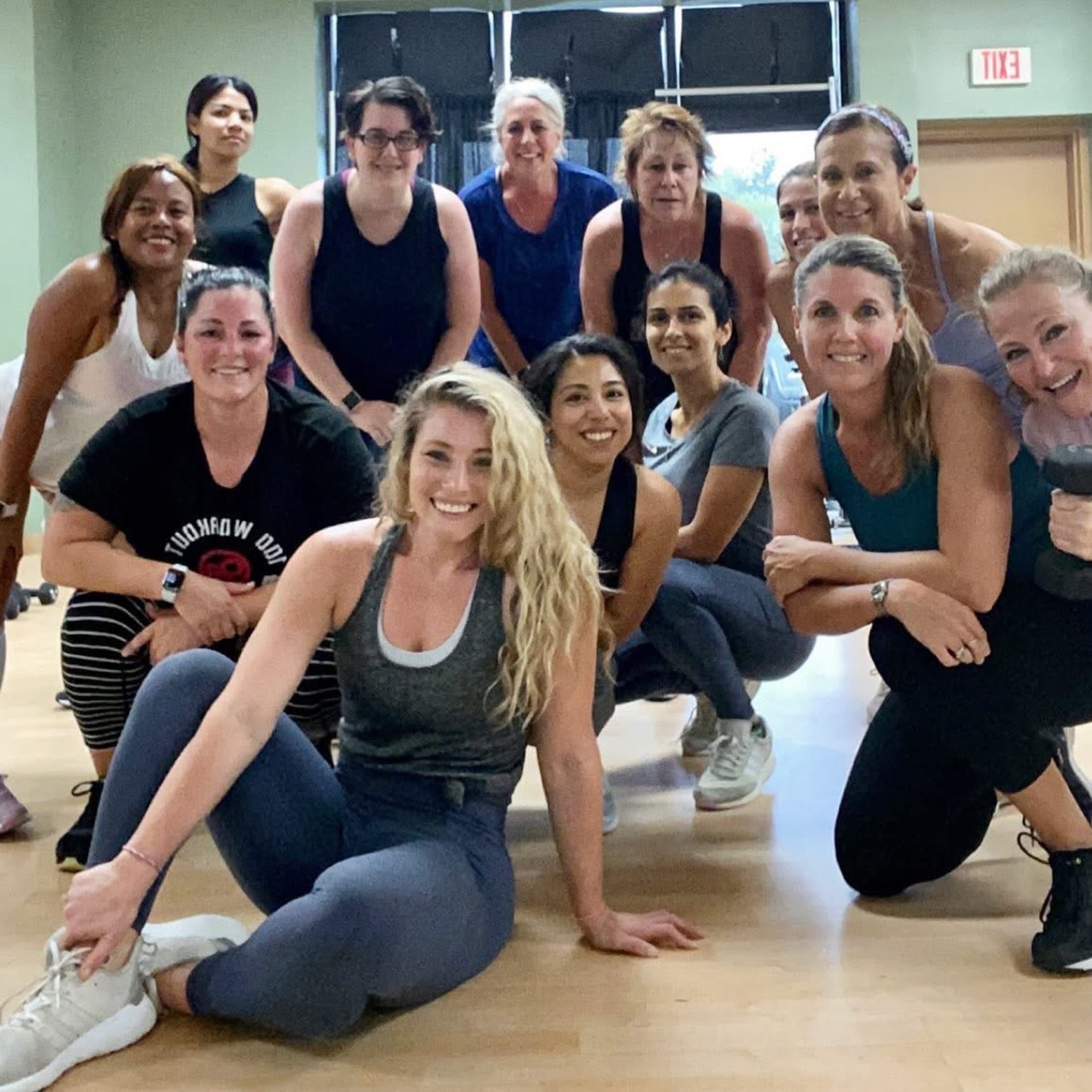 Tricia Martin with a smiling group fitness class